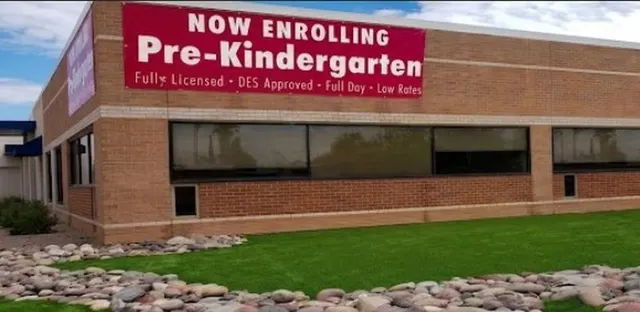 The Tucson site: a long brick building behind a lawn, with a banner reading “Now Enrolling Pre-Kindergarten — Fully Licensed, DES Approved, Full Day, Low Rates”.